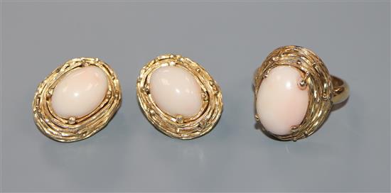 A pair of 18k yellow metal and cabochon coral set earrings and matching dress ring.